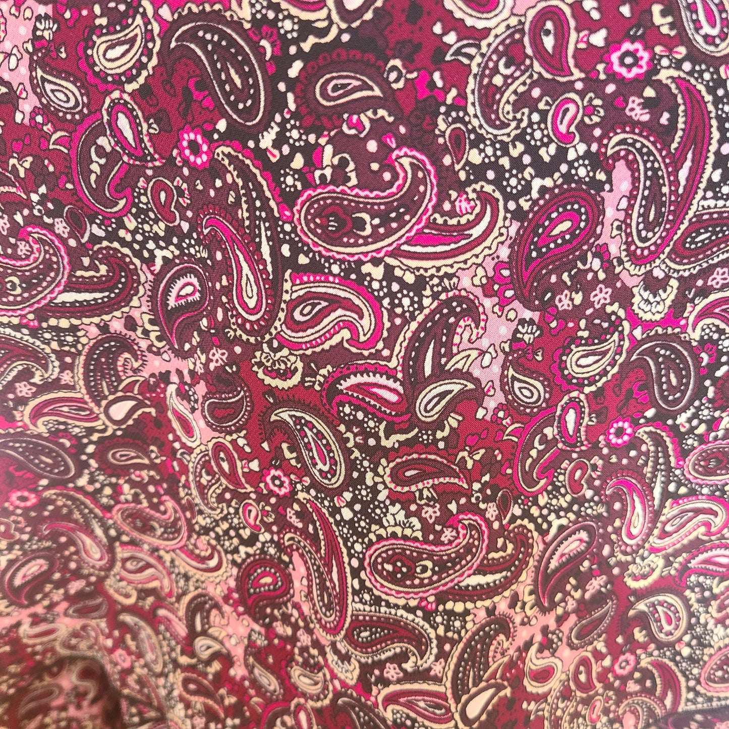 Patterned fabric with purple, pink and brown paisley design